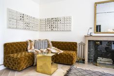 a living room filled with furniture and a fire place next to a wall mounted mirror