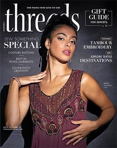 a woman in a purple dress on the cover of threads magazine, with her hand on her shoulder