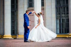 a bride and groom standing in front of a building