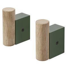 two wooden blocks with one green block on the other