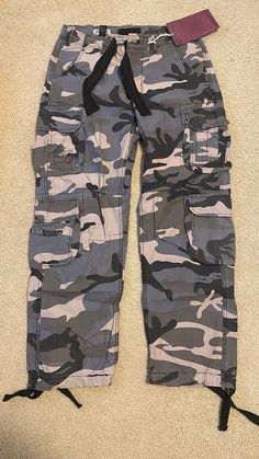 These are the Vintage Brand Cargo Pants from Europe. This is a size medium in Men's size. Color, Gray Camo Style (multiple shades of gray camouflage). Brand new with tags. These are trending on Tik Tok and portray the style of Y2K/vintage fashion. If you're in the U.S. you can skip the 3-4 week shipping time, cost, & taxes from Europe and purchase mine. Shipped from the U.S. Purple Camo Pants, Purple Camo, Gray Camo, Camo Fashion, Camo Pants, Training Pants, Grey Pants, Vintage Branding, Shades Of Grey