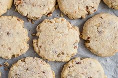 a bunch of cookies sitting on top of a piece of wax paper next to each other