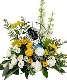 a basket filled with yellow and white flowers