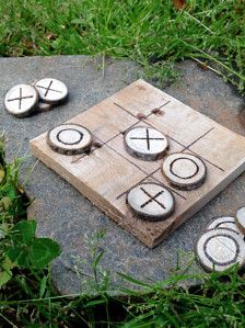 a wooden board game sitting on top of a rock