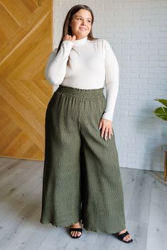 Get ready to make a statement with our Harmony High Rise Wide Leg Pants! Boasting a smocked waistband, textured fabric, and a dramatic wide leg, these iconic pants will make you stand out wherever you go. With a subtle polka dot print, you'll add a touch of glamour to any look. Crinkle Woven High Rise Smocked Elastic Waistband Pockets Wide Leg 100% Polyester True to Size S: Waist 26-30" Hip 46" Rise 13.5" Inseam 27"M: Waist 28-32" Hip 48" Rise 13.5" Inseam 27"L: Waist 30-34" Hip 50" Rise 14" Ins