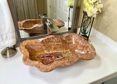 a bathroom sink sitting on top of a counter next to a mirror