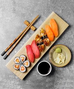 sushi and chopsticks on a wooden board