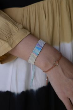 a woman's arm with a bracelet on it