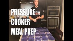 a man standing in front of a counter filled with purple plates and pans next to an oven