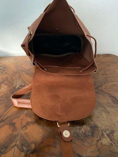 "Backpack bag, brown faux leather backpack,Converts to shoulder bag, mint condition, Whiskey brown Top loop handle for carrying Flap over and Snap clasp closure. 2 front snap close pockets PLEASE SEE MEASUREMENTS Measures: 12\" tall x 10\" x 5.5\" deep Straps: adjustable Should strap drop is 12\" NK216B3 Backpack bag, brown faux leather backpack,Converts to shoulder bag, mint condition, Whiskey brown" Leather Sling Bags, Faux Leather Backpack, Leather Sling Bag, Perfect Together, Brown Top, Backpack Bag, Sling Bag, Saddle Bags, Leather Backpack