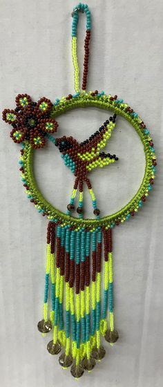 a colorful beaded necklace hanging on a wall