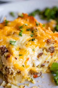 a close up of a plate of food with broccoli and cheese on it