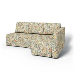 a couch that is sitting on top of a white surface with flowers and plants all over it