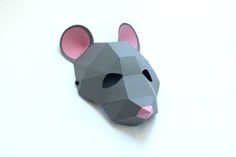 a paper mouse mask on a white surface