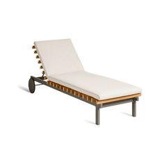 an outdoor chaise lounge chair with white cushions and wooden slatted backrests