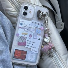 a cell phone case with various stickers and tags attached to the back of it