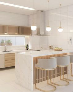 a modern kitchen with marble counter tops and stools