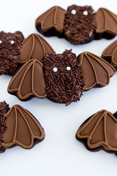 chocolate bats decorated with sprinkles on white surface