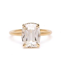 an oval cut diamond ring in yellow gold with a single stone on the front and side