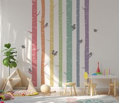 a child's room with colorful trees and birds painted on the wall