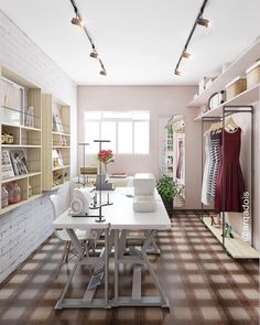 a room that has some clothes on racks in it and a table with two chairs