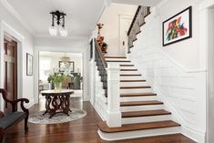 a living room filled with furniture and a staircase