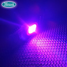 a close up of a purple light in the dark