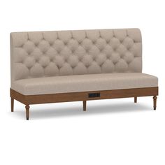 a beige couch sitting on top of a wooden frame