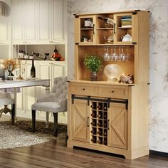 a dining room table and chairs in front of a wooden cabinet with wine glasses on it