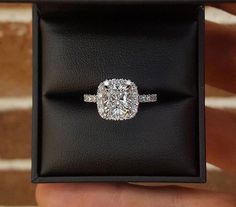 an engagement ring in a black box