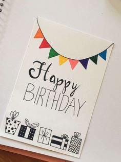 a happy birthday card on top of a desk next to a pen and laptop computer