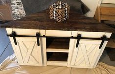 a white cabinet with black hardware and a bow on top