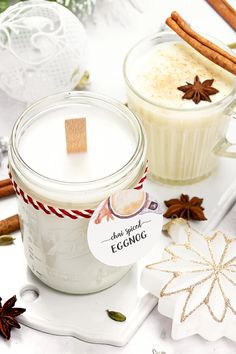 two glass jars filled with different types of food and cinnamon sticks on top of a white tray