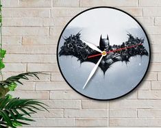 a clock that is on the wall with a batman symbol in it's center