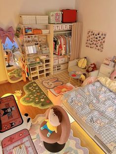 this is a room with toys and other items on the floor, including a bed