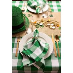 a table set for st patrick's day with plates, silverware and green napkins