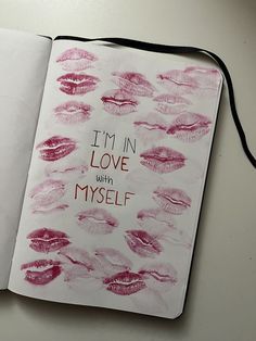 an open notebook with lipstick drawn on it and the words i'm in love with myself