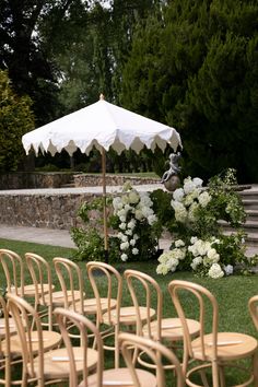 chairs and an umbrella are set up in the grass