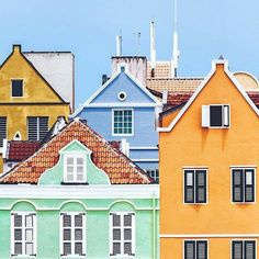 many different colored buildings with windows and shutters