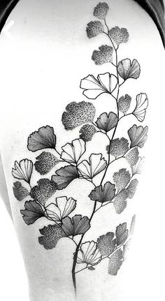 a black and white photo of a flower tattoo