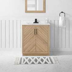 a bathroom with a sink, mirror and rug