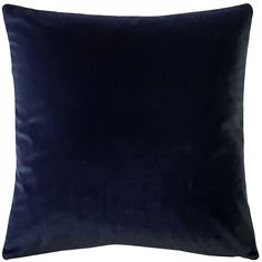 a dark blue velvet pillow on a white background