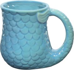 a blue ceramic mug with fish scales on it