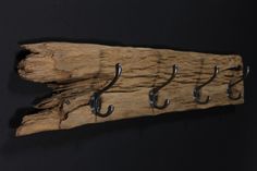 a piece of driftwood has hooks on it