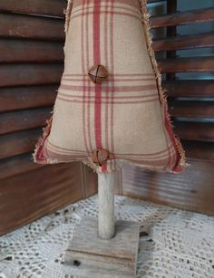 a burlap christmas tree on a wooden stand