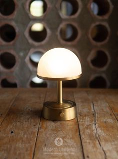 a small white light sitting on top of a wooden table