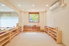 a room filled with lots of wooden shelves