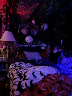 a bed in a dark room with many decorations on the wall and ceiling above it