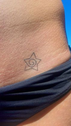 a woman's stomach with a small tattoo on it