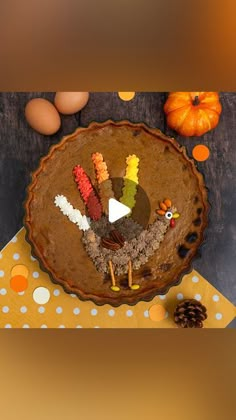 a thanksgiving pie decorated with turkeys and eggs